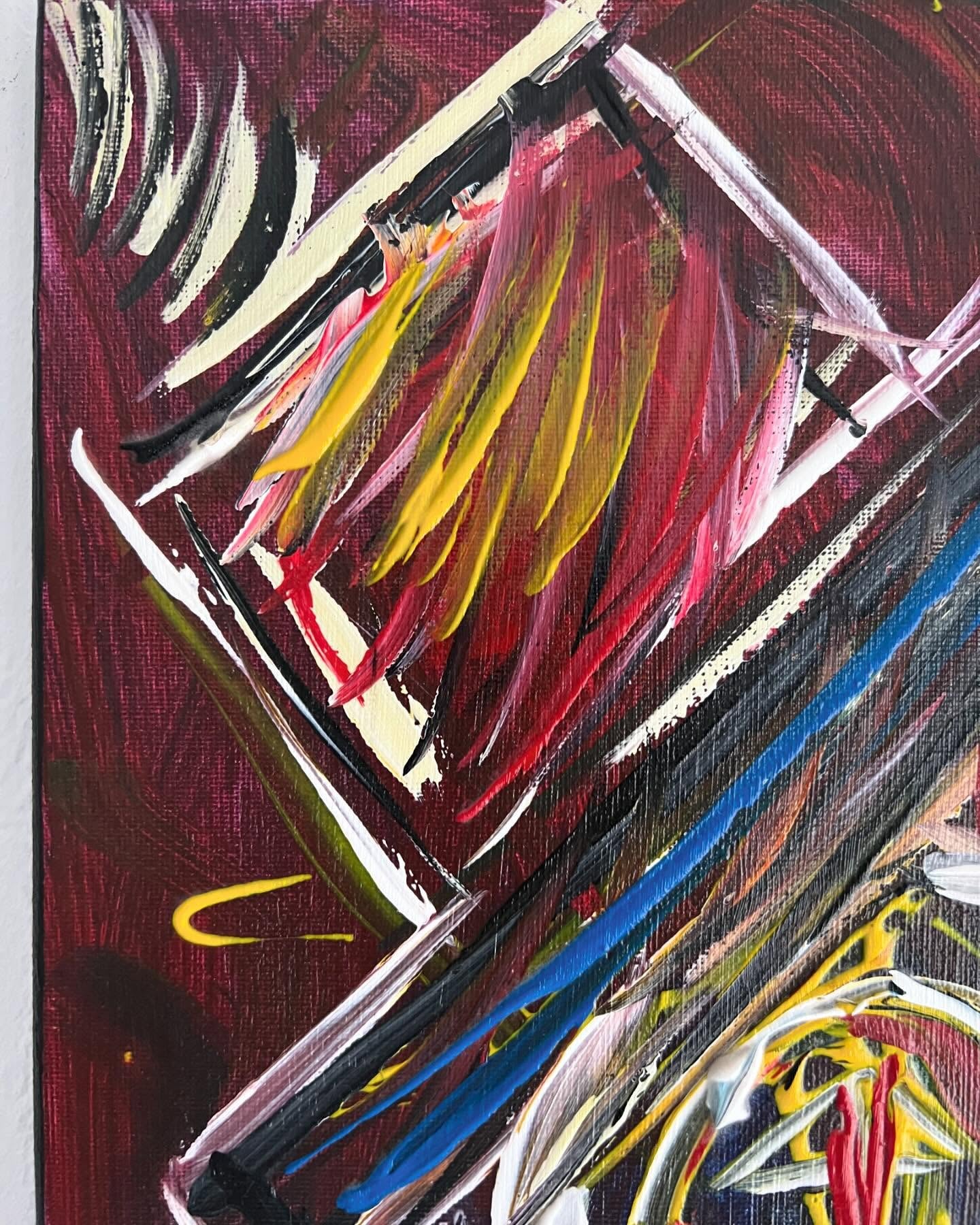 Abstract painting with bold strokes of red, yellow, blue, and white on a dark background