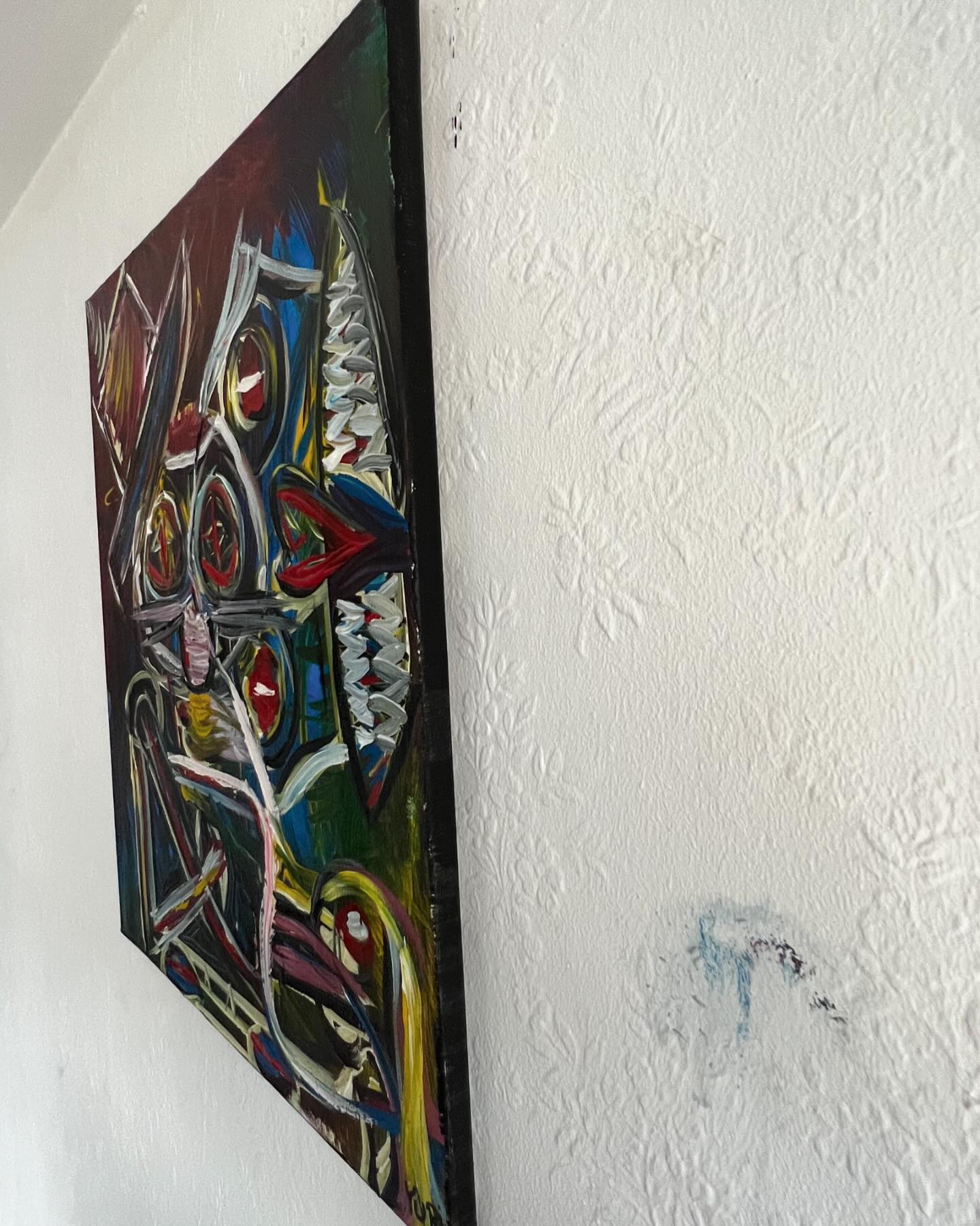 Colorful abstract painting on a textured white wall