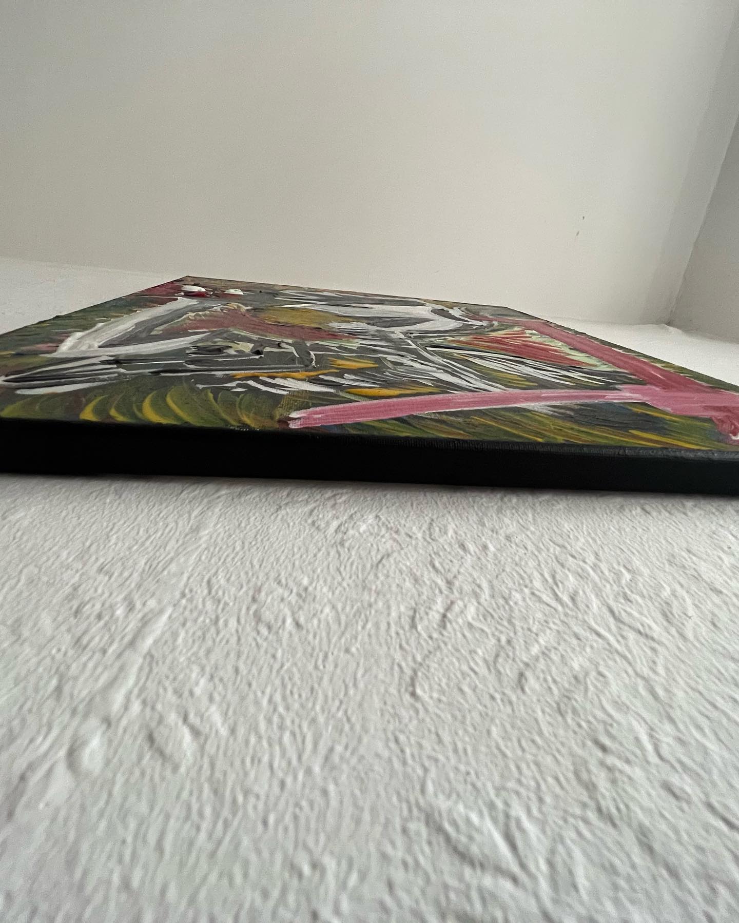Abstract painting on a textured white surface