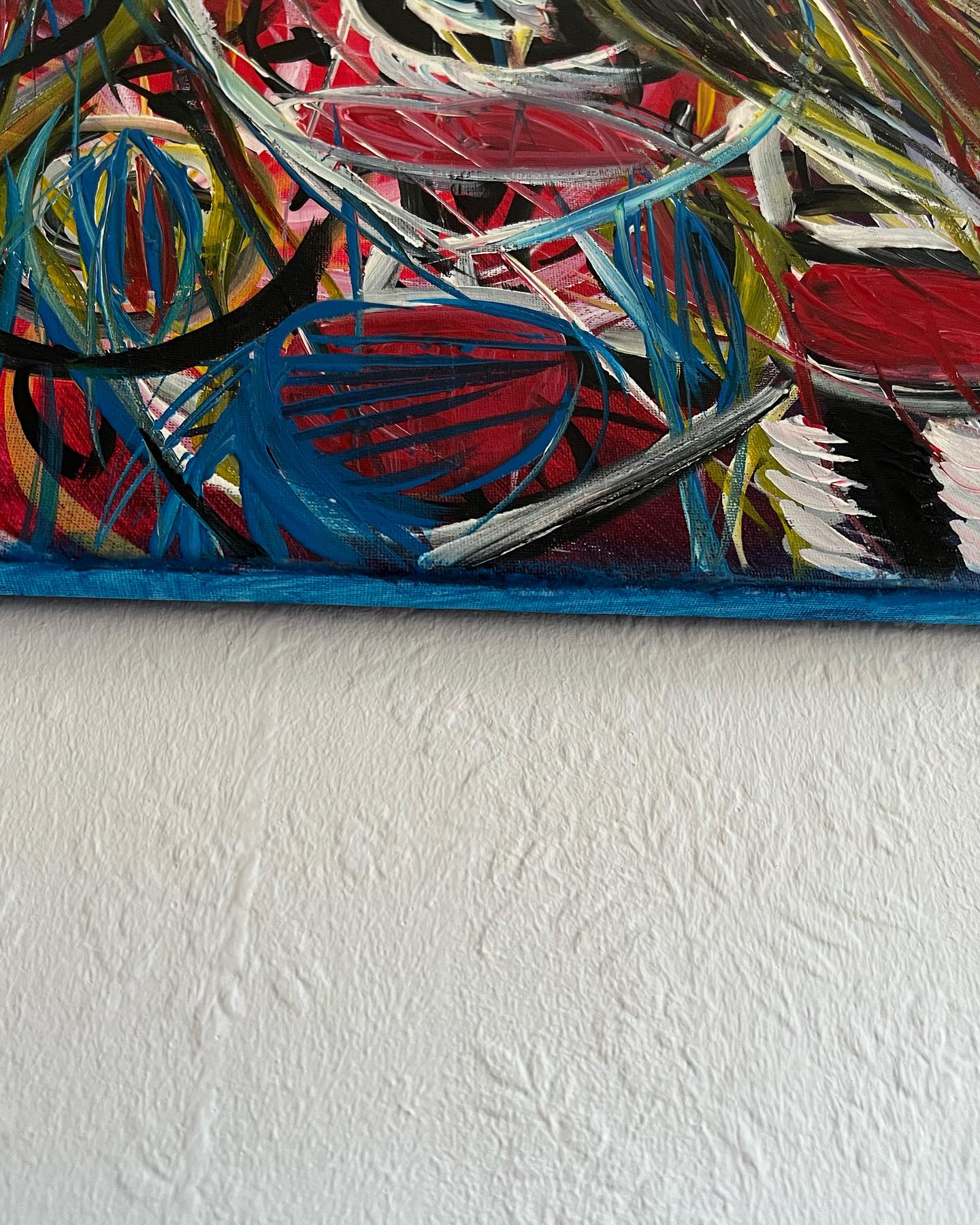 Abstract painting with multicolor brush strokes on a white wall
